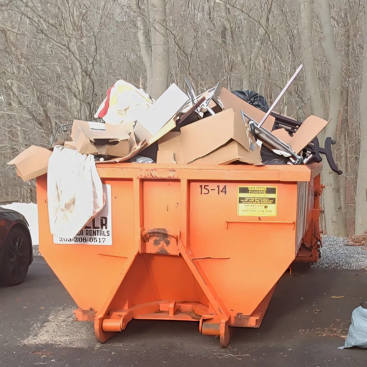 Overloaded dumpster with construction debris leaning dangerously high in Branford CT